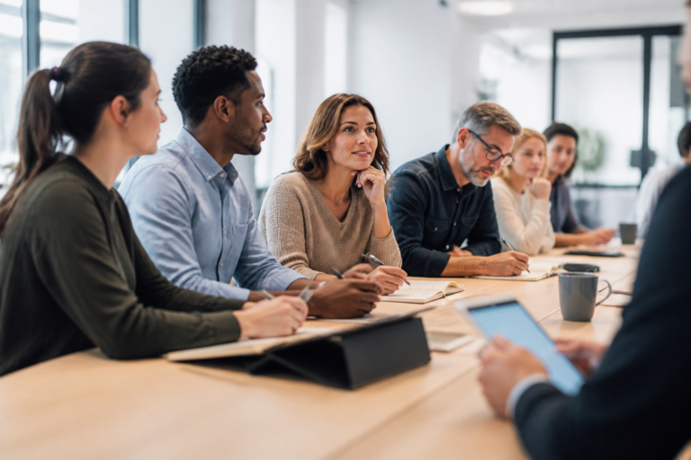 Professionnels en formation collaborant autour d'une table lors d'un atelier